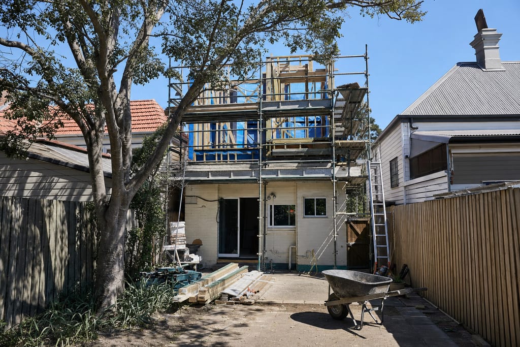 Narrow Sydney terrace with a second storey house extension underway above small backyard
